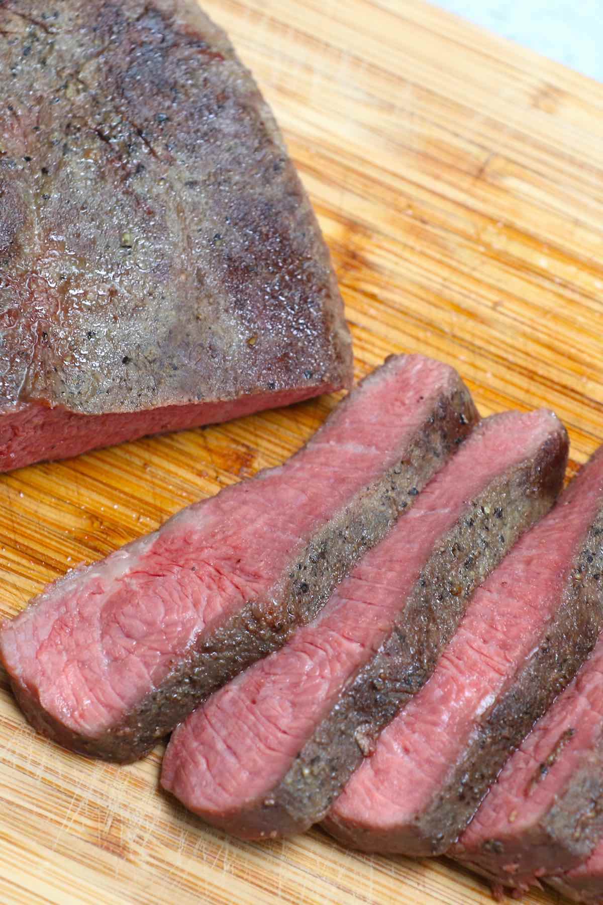 Slices of beef cooked medium with a warm pink interior