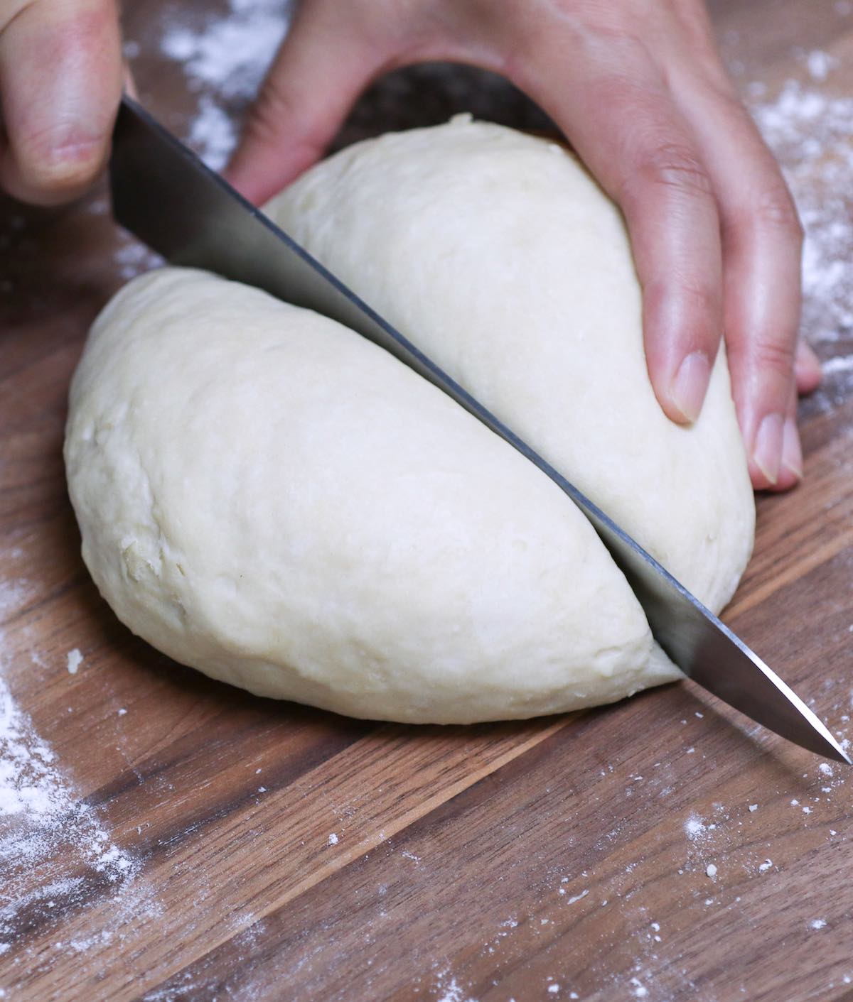 Cutting the dough using a sharp knife on the cutting board