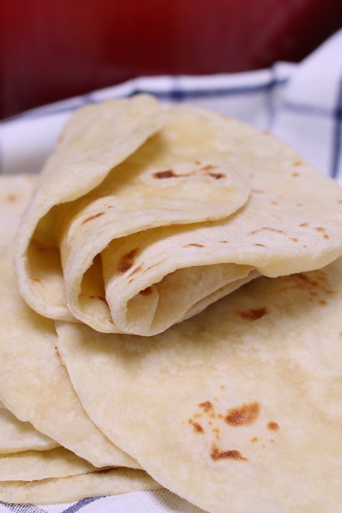 Homemade Flour Tortillas are soft, tender and fluffy – a delicious Mexican thin flatbread made from scratch! It’s easy to make with only 5 simple ingredients, and can be done completely by hand!