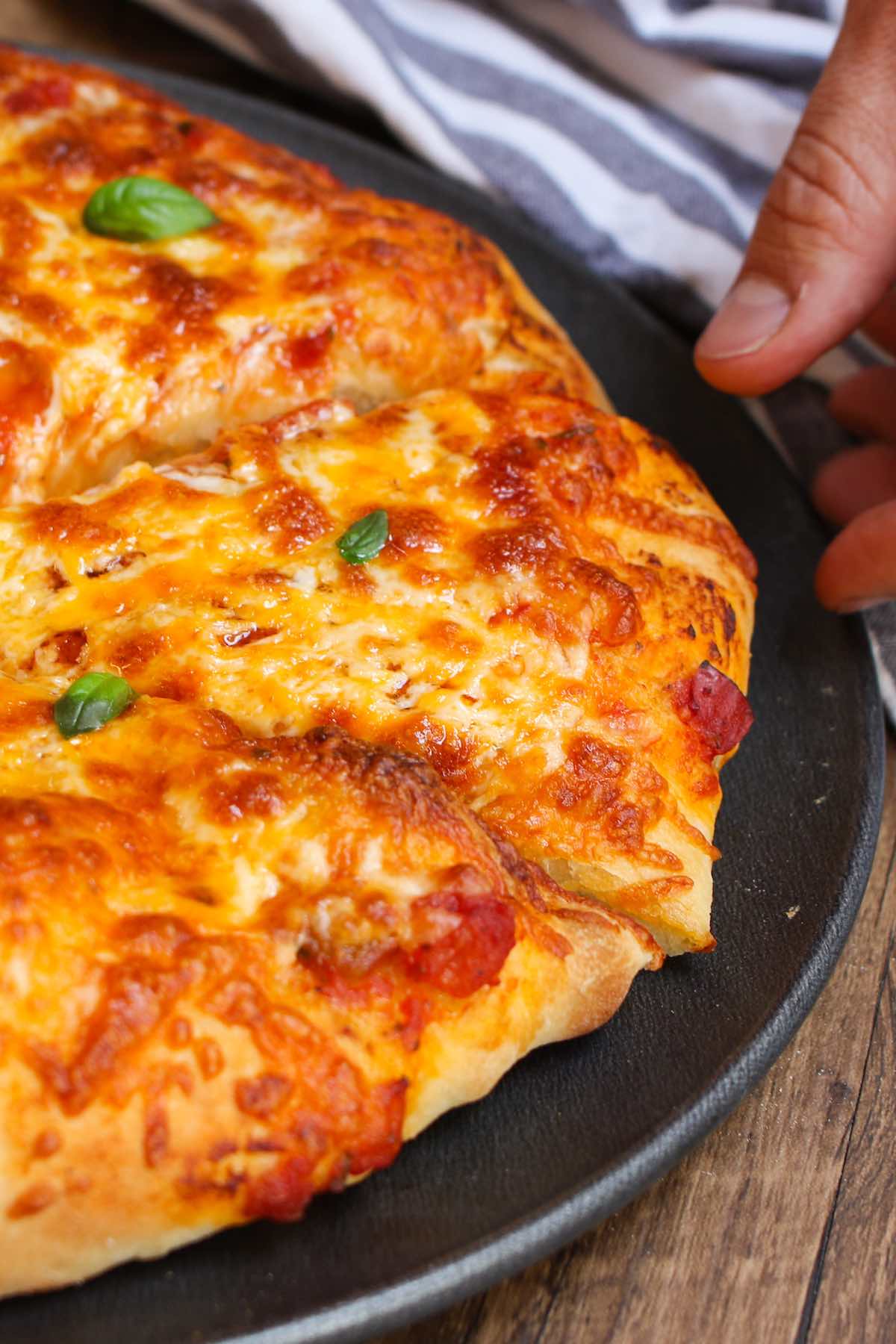 This Easy Pizza Dough Recipe makes soft and fluffy pizza crust that’s beyond irresistible! It’s the best homemade pizza dough that has been passed down through generations. It takes 10 minutes to prepare and made by hand with 6 simple ingredients!