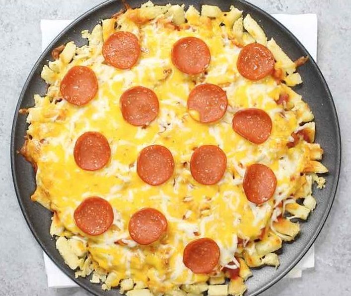 Overhead view of a pepperoni pizza with a french fry crust