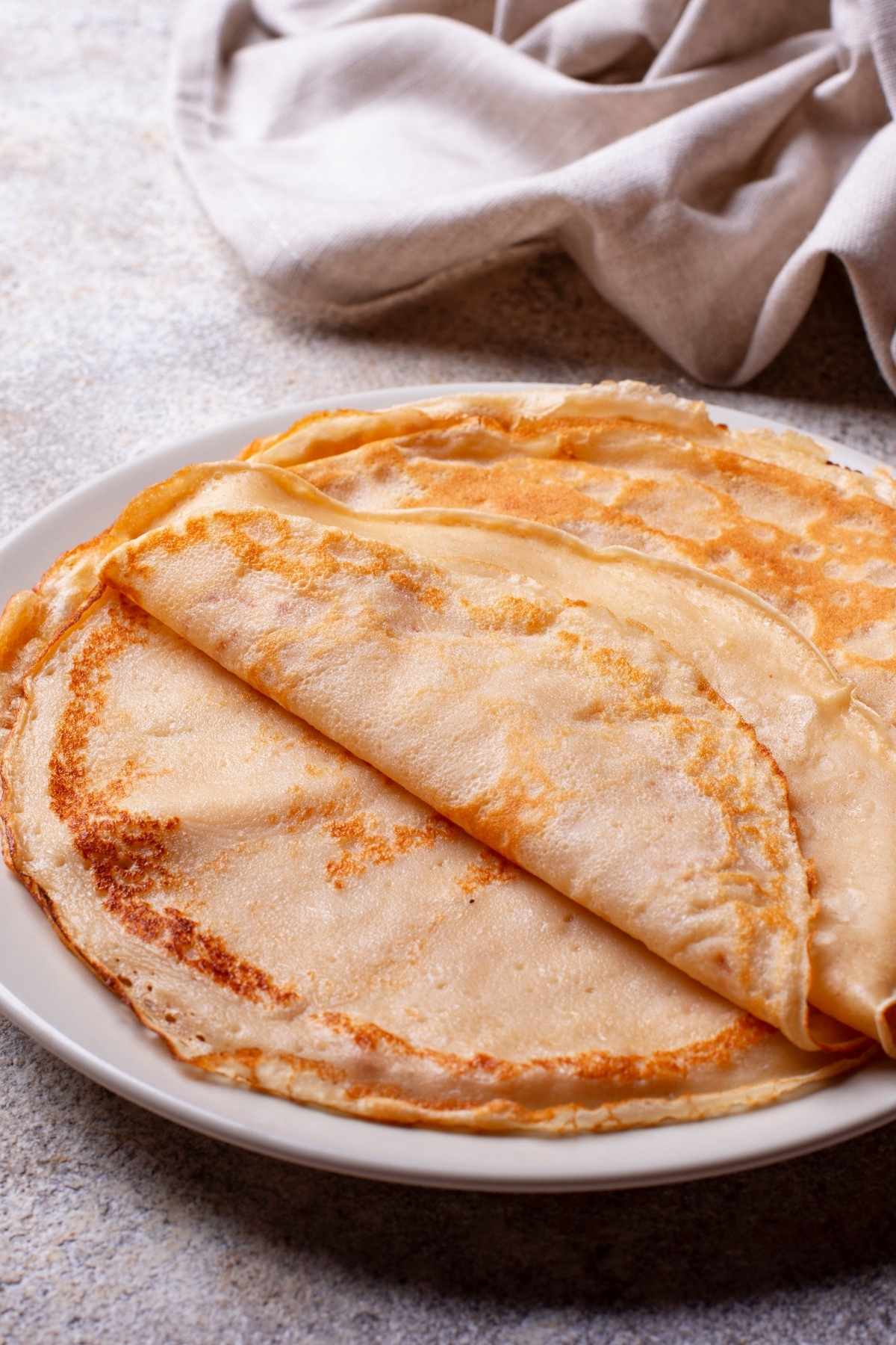 Stack of freshly made crepes on a plate