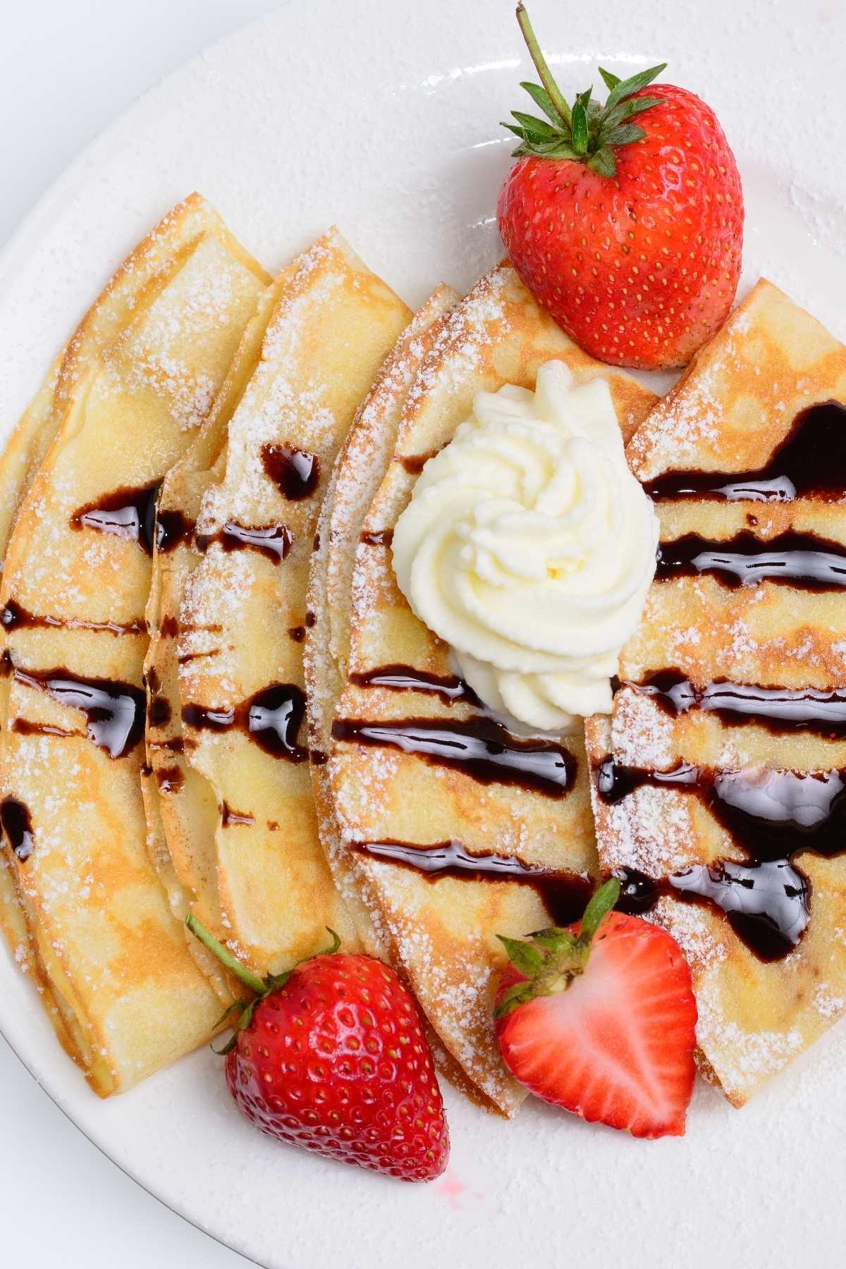French pancakes with chocolate sauce and whipped cream