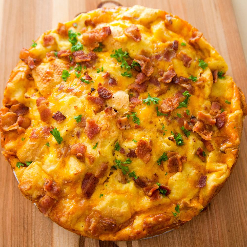 A fluffy and perfect Frittata – loaded with bacon, cheese, eggs and vegetables. Once you know the basics, the filling options are endless. It takes less than 20 minutes and is a great recipe to clean out the refrigerator!