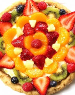 Fruity Pizza - The easiest and most unbelievably beautiful fruit pizza or fruity sugar cookie cake has a soft sugar cookie crust and smooth creamy filling, topped with fresh fruits. All you need is a few simple ingredients: refrigerated sugar cookie dough, cream cheese, sugar, vanilla extract and fruit of your choice! A simple dessert you whole family will be obsessed with. It takes only 20 minutes to make. Perfect for holiday party dessert such as Easter, Mother’s Day, Father’s Day or birthdays. Quick and easy, vegetarian. Video recipe. | tipbuzz.com