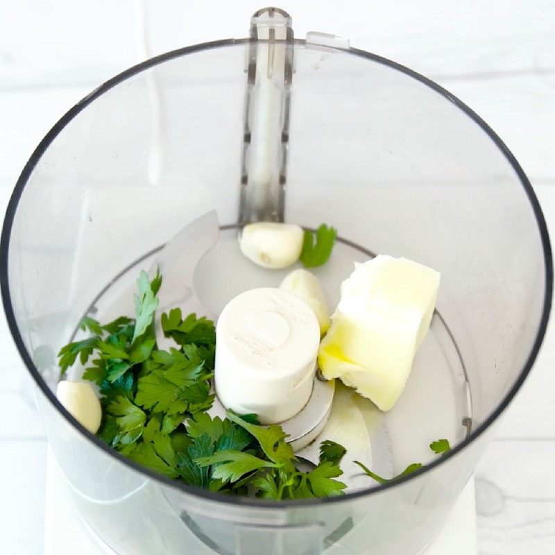 Combining butter, garlic and Italian parsley in a food processor