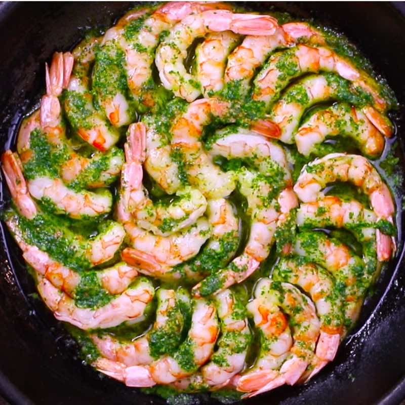 Overhead view of garlic butter parsley shrimp in a cast iron skillet