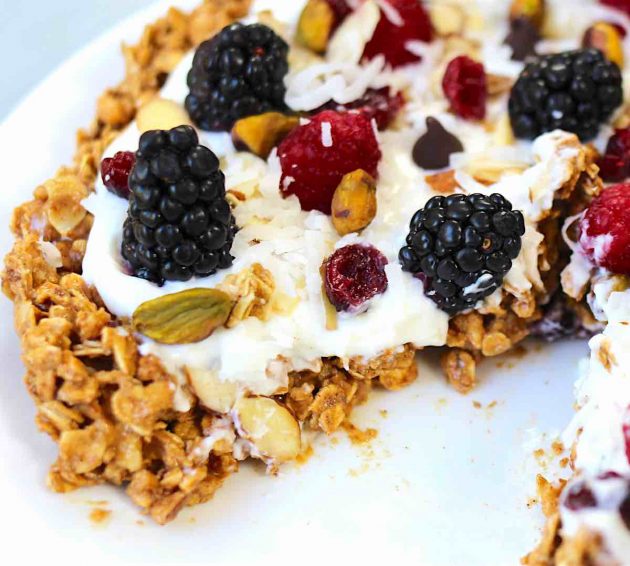 Healthy Breakfast Pizza With Granola Crust – A healthy and delicious recipe that’s easy to make with a few simple ingredients: granola, peanut butter, almonds, cinnamon, yogurt, berries and nuts. A perfect, vegetarian breakfast or brunch idea. So yummy! Video recipe. | tipbuzz.com