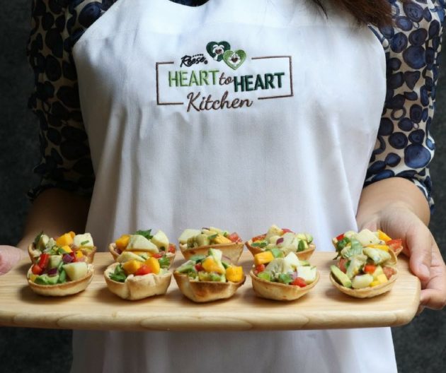 This photo shows hearts of palm ceviche cups, a bowl of the ceviche salad filling and Reese brand hearts of palm and artichoke hearts packages used to prepare the recipe