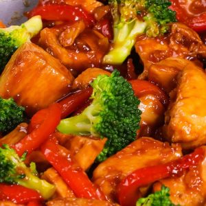 This chicken stir fry recipe features tender chunks of chicken with garlic, broccoli and bell pepper in a sweet and savory sauce, for a weeknight dinner that's easy to make in 20 minutes