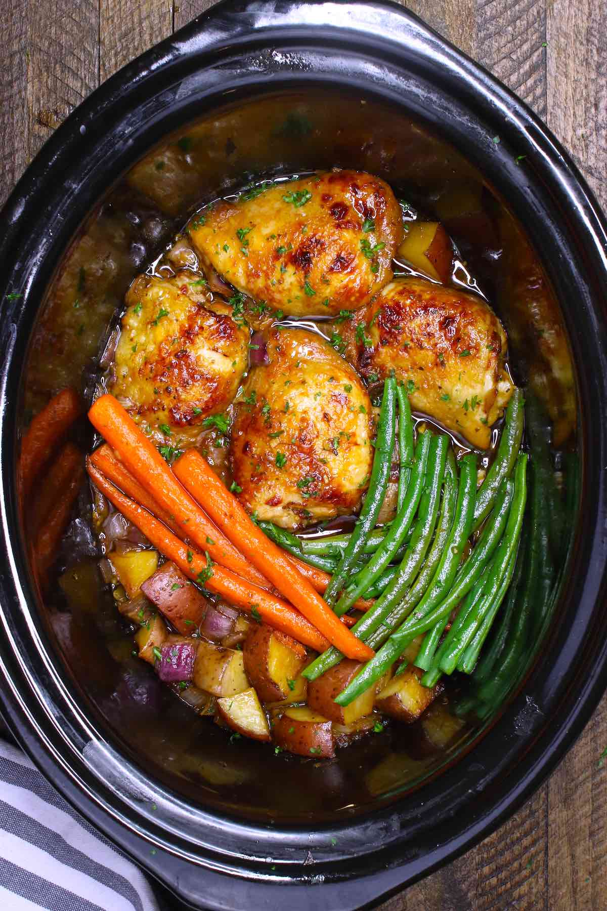 Honey garlic chicken in the crock pot with potatoes, carrots and green beans