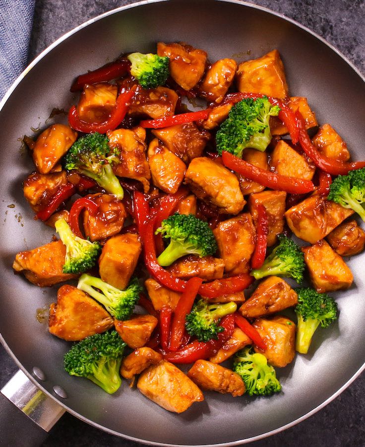 Overview of freshly made chicken vegetable stir fry in a skillet