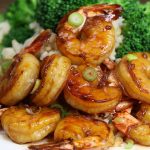 Honey Garlic Shrimp__ The easiest, most unbelievably delicious Honey Garlic Shrimp. And it’ll be on your dinner table in just 15 minutes. Succulent shrimp marinated in honey, garlic, soy sauce and ginger mix, seared in frying pan. Ready in 15 minutes! Quick and easy dinner recipe. Video recipe. | Tipbuzz.com