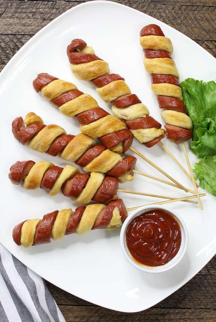 Crescent Roll Hot Dogs are an easy party appetizer with just 3 ingredients: hot dogs, crescent roll dough and egg wash. Perfect for game day parties, birthdays and just everyday fun. 