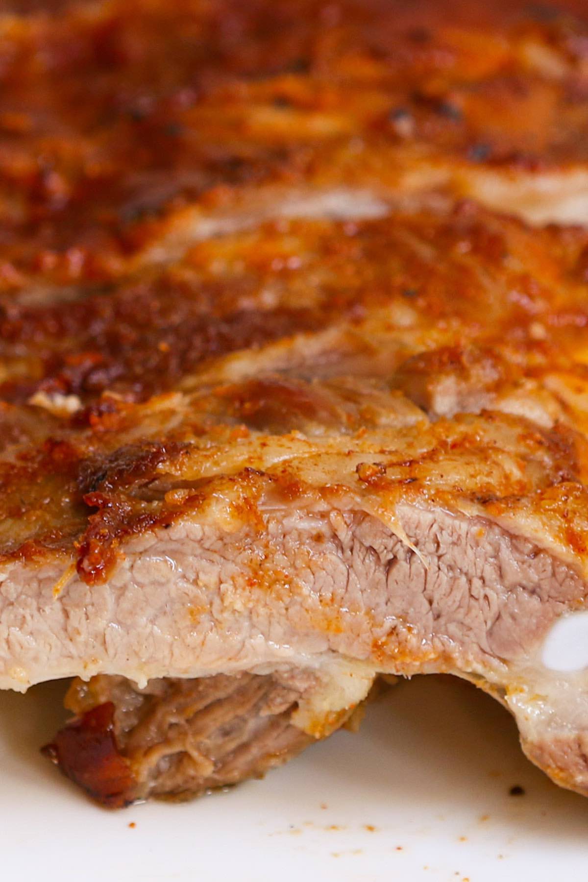 A close-up of a perfectly grilled rib with juicy meat and caramel crust