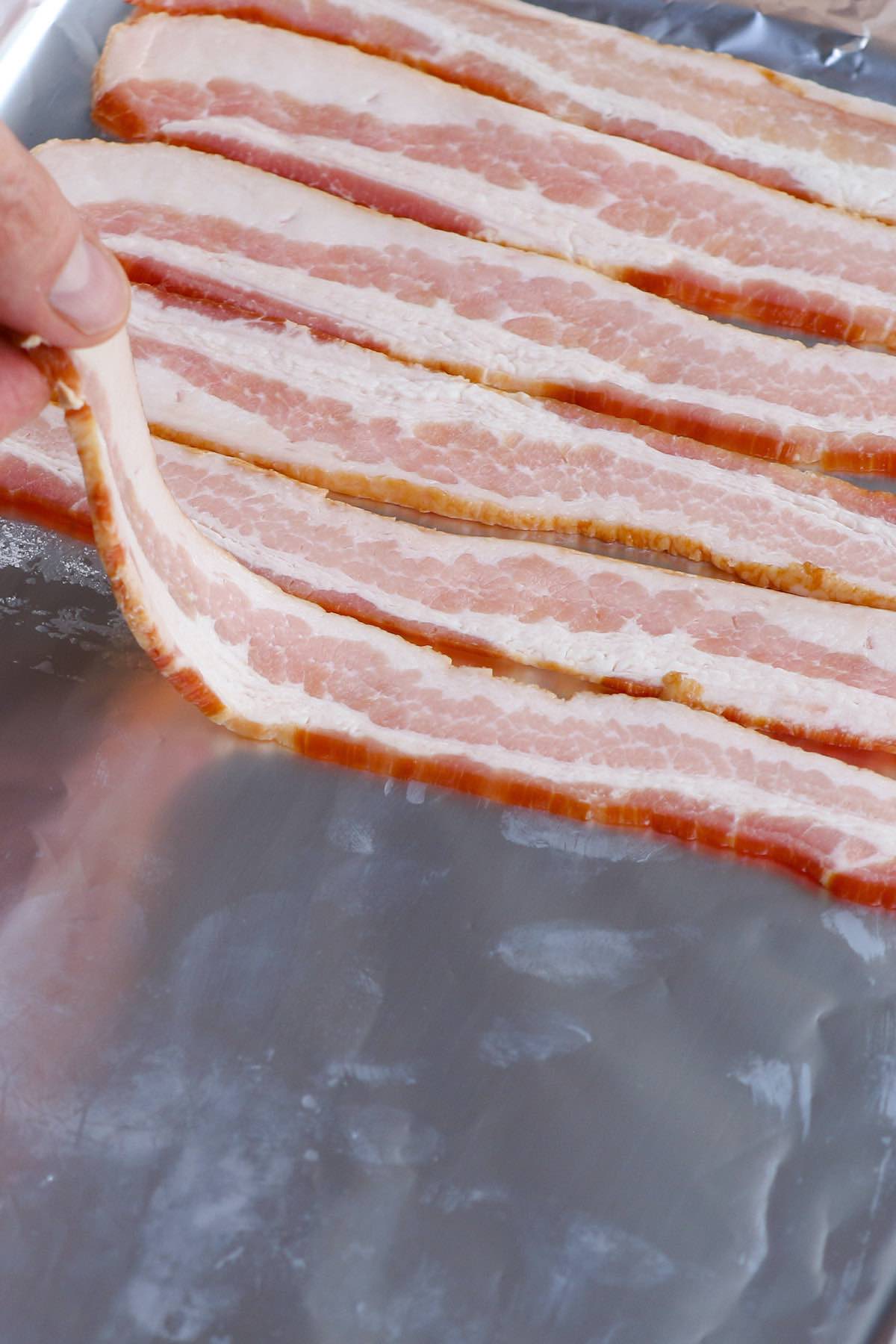 Photo showing putting the bacon directly into the baking dish covered with foil.