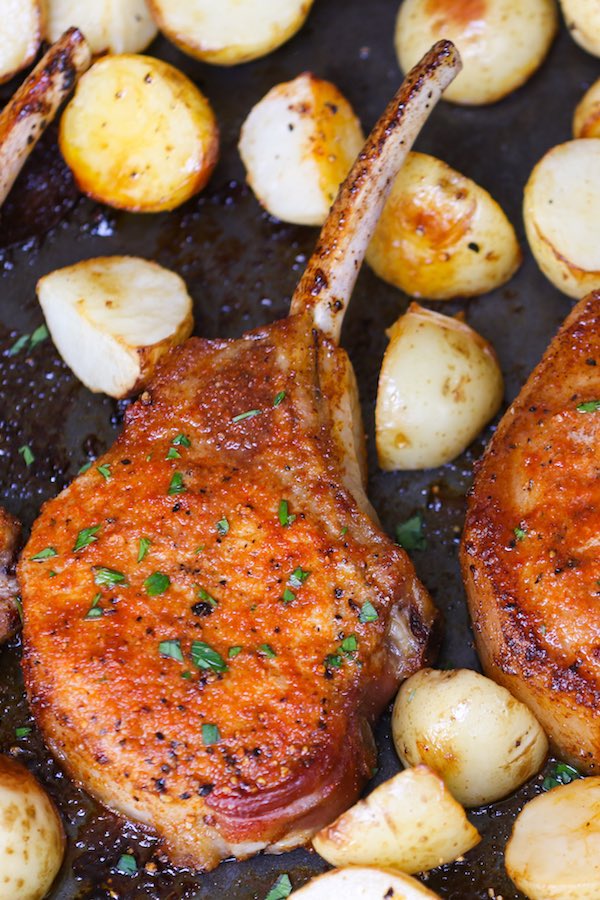 This photo shows how long to cook pork chops in the oven, which is until you have a golden caramelized crust that is crispy with juicy and tender meat inside