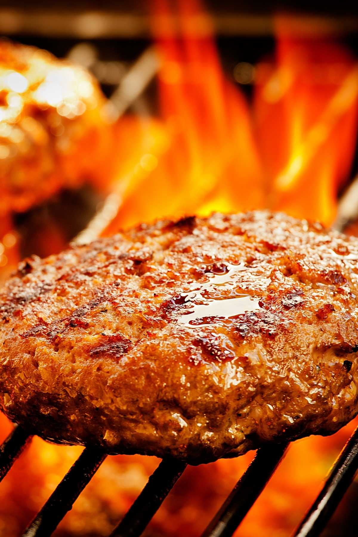 Closeup of a hamburger patty on a BBQ