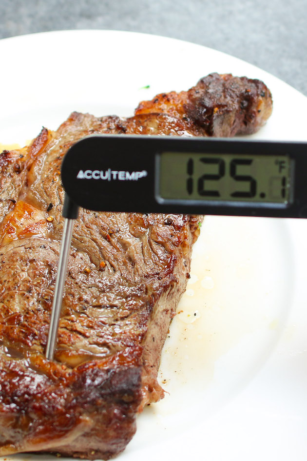 Checking steak doneness using an instant-read thermometer