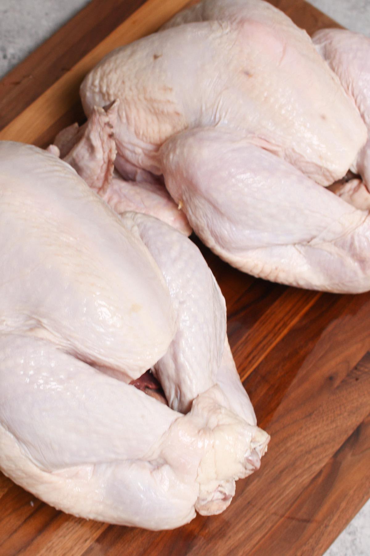 Display of a 12 lb and 15 lb turkey on a cutting board. They require different cooking times.