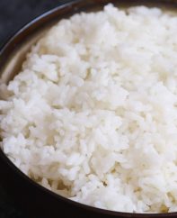 Fluffy microwave rice in a serving bowl ready to combine with other dishes to make a delicious meal