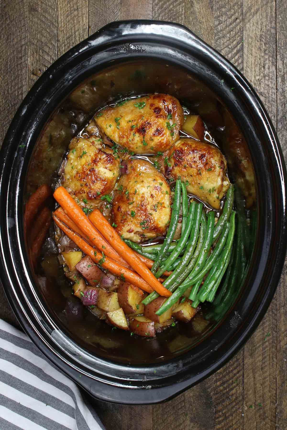 Making honey garlic chicken thighs with vegetables in the slow cooker