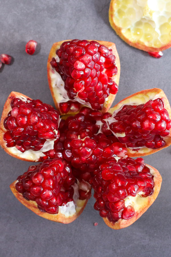 This photo shows how to cut a pomegranate correctly and reveal the beautiful arils inside for a delicious and healthy snack