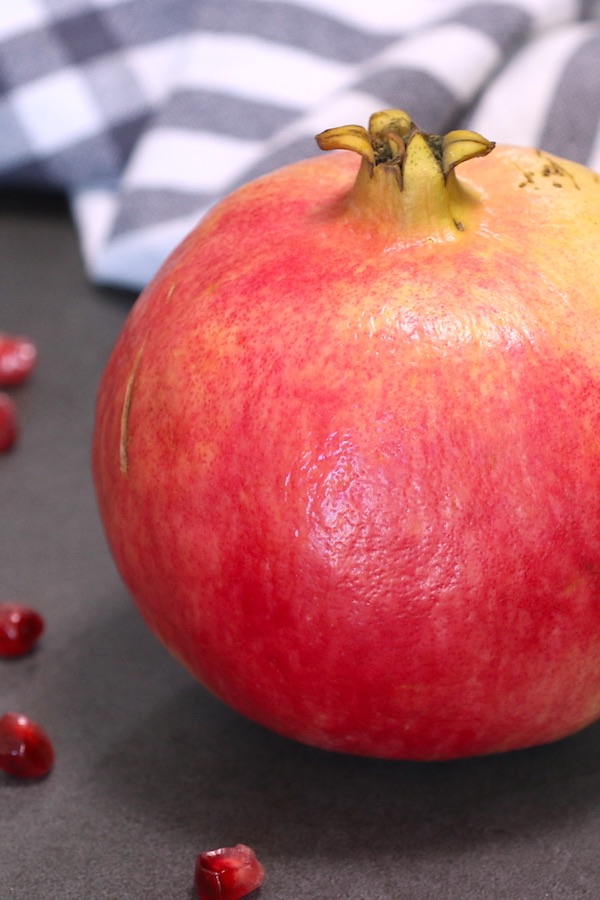 A large ripe pomegranate ready to be cut open and eaten