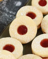 These soft and buttery homemade Jammie Dodgers are a UK staple! They are two shortbread biscuits sandwiched together with fruity jam such as strawberry or raspberry.