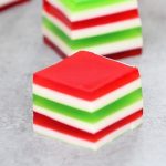 Easy Layered Jello Shots – An easy and beautiful dessert spiked with vodka for a special party! Smooth and creamy Jello shots with bright red, green and white layers. All you need is a few simple ingredients: gelatin, strawberry and lime jello powder, vodka and condensed milk. So Good! Great for holiday and birthday parties. Easy recipe, party desserts. Finger food. No Bake. Vegetarian. Video recipe.
