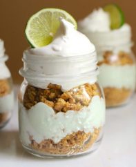 No Bake Key Lime Pie In A Jar – smooth, creamy and tangy key lime cheesecake is layered between crunchy crashed graham crackers. Served in individual mason jars. It’s so easy and comes together in 10 minutes. All you need is a few simple ingredients: crushed graham crackers, butter, cream cheese, condensed milk, vanilla greek yogurt, key lime juice, green food coloring, whipped topping and slices of lime to garnish. So good! Quick and easy, no bake dessert, vegetarian. Video recipe. | tipbuzz.com
