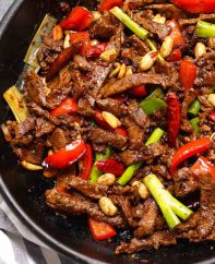 Stir fried Szechuan beef and vegetables in a cast iron skillet