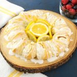 Quick And Easy Lemon Cheesecake Crescent Ring (video recipe) - bursting with irresistible lemon flavour! Tender and flaky crescent ring filled with creamy lemon cheesecake and topped with lemon zest! All you need is a 7 simple ingredients: cream cheese, lemon juice, lemon zest, sugar, crescent roll dough and milk. Perfect for Easter or any holiday breakfast or brunch! Vegetarian. | tipbuzz.com