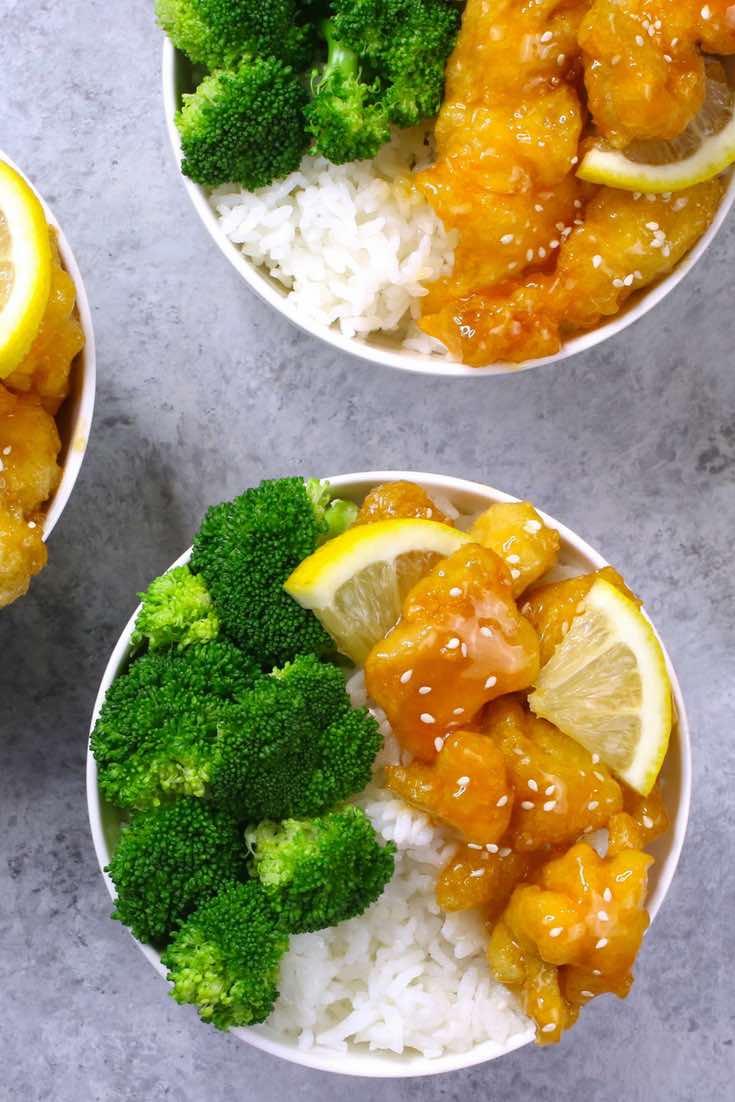 The easiest, crispy and most unbelievably delicious Lemon Chicken with Rice Bowls. So much better than take outs! All you need is only a few ingredients: chicken breast, lemon, salt & pepper, egg, oil, sugar, and cornstarch. One of the best Asian dinner ideas! Served with rice and broccoli. Quick and easy dinner recipe. Video recipe. | Tipbuzz.com