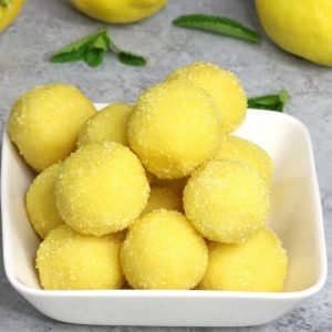 Super Easy Lemon Truffles – these flavorful lemon cake batter truffles are so easy to make and they look absolutely beautiful! It takes only 15 minutes. All you need is only 5 simple ingredients: lemon cake mix, butter, sugar, lemon and yellow sprinkles. Quick and easy recipe. Dessert, party recipe. Vegetarian. Video recipe. | Tipbuzz.com