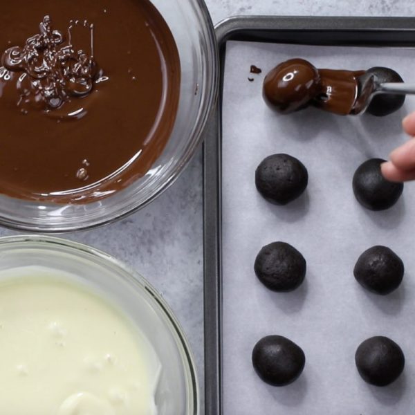 4 Ingredient Oreo Truffles - this photo shows how to dip oreo cheesecake balls into semisweet chocolate or white chocolate when making oreo truffles