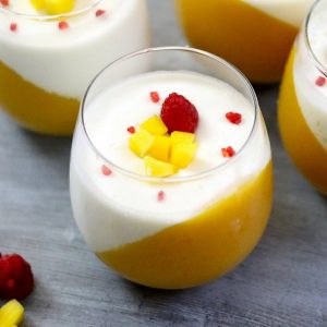 The Best Mango Panna Cotta – looks so elegant and tastes so delicious that you won’t believe how easy it is to make! Creamy, rich and smooth dessert topped with fresh mango and raspberries. All you need is some simple ingredients: fresh mango, mango juice, gelatin, milk, heavy cream and vanilla extract. Wow your guest with this refreshing dessert at your next party! No bake, easy dessert. Video recipe.