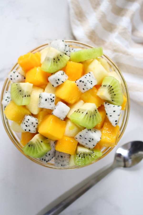 A fresh fruit salad is an easy way to use cut mango. This bowl of salad features cubes of mango with kiwi, dragon fruit and pineapple