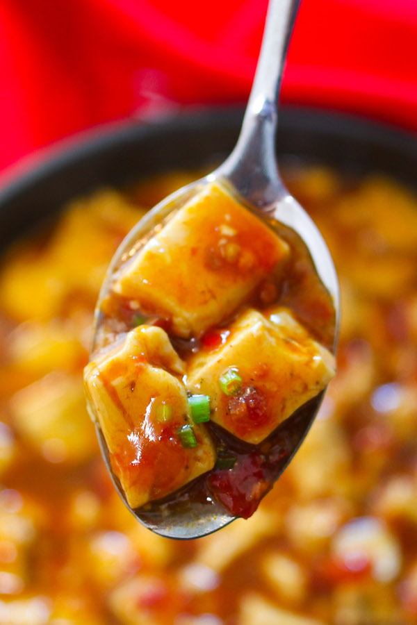 A spoonful of spicy Mapo Tofu ready to be eaten