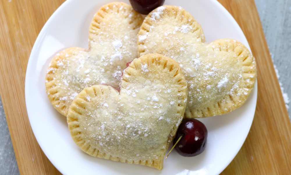 Mini Cherry Pies made in a heart shape and dusted with powdered sugar for a winning presentation