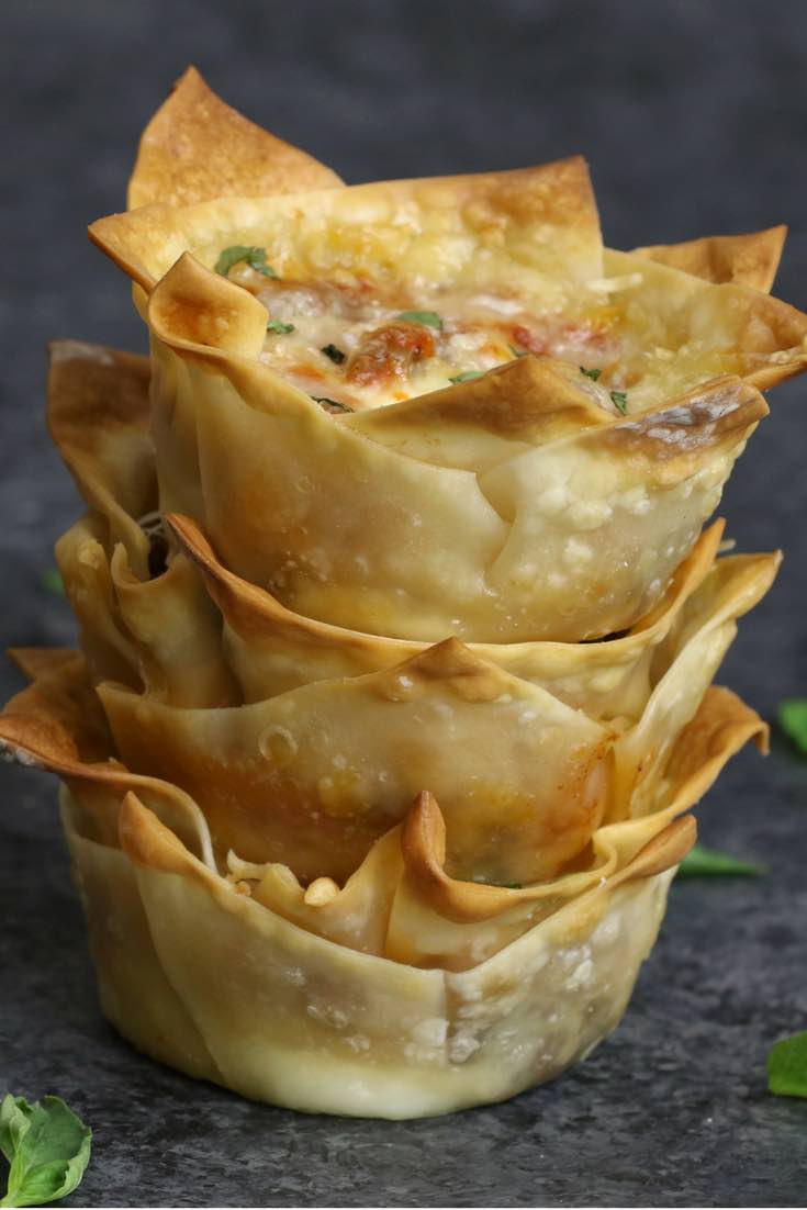 A stack of lasagna cups showing crispy edges and cheesy filling