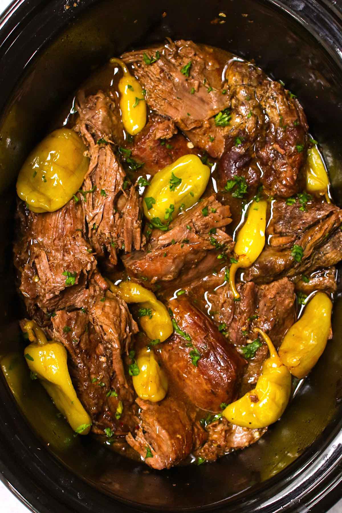 Fork tender cooked Mississippi pot roast in a slow cooker.