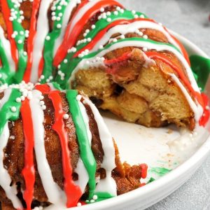 Delicious homemade Monkey Bread for the holidays with raisins, nuts and colorful icing for a festive look. There's nothing more comforting or satisfying for breakfast, brunch or a party.