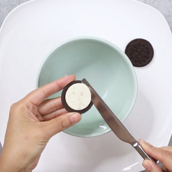 Oreo Cake - this photo shows how to separate oreo creams from the cookies using a knife
