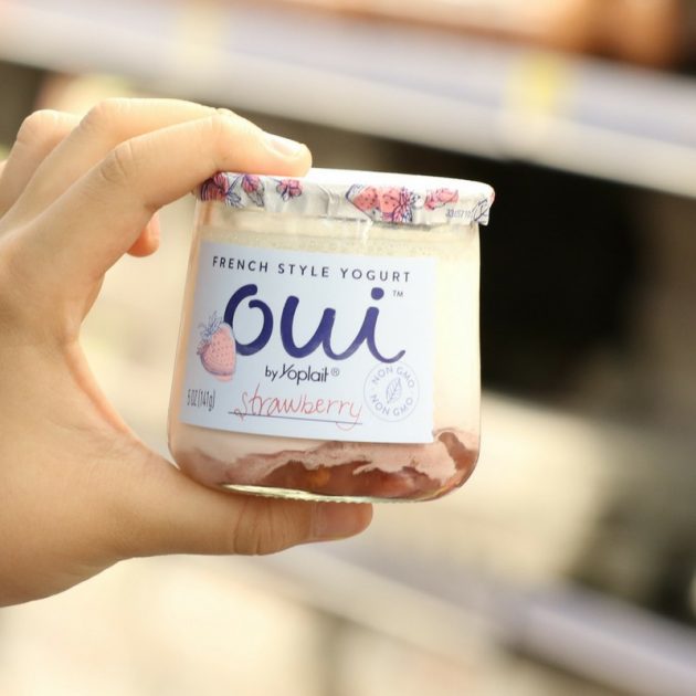 This is a close-up photo of a container of Oui By Yoplait strawberry flavor French-style yogurt
