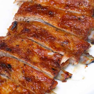 Closeup of oven baked St Louis style ribs on a serving platter