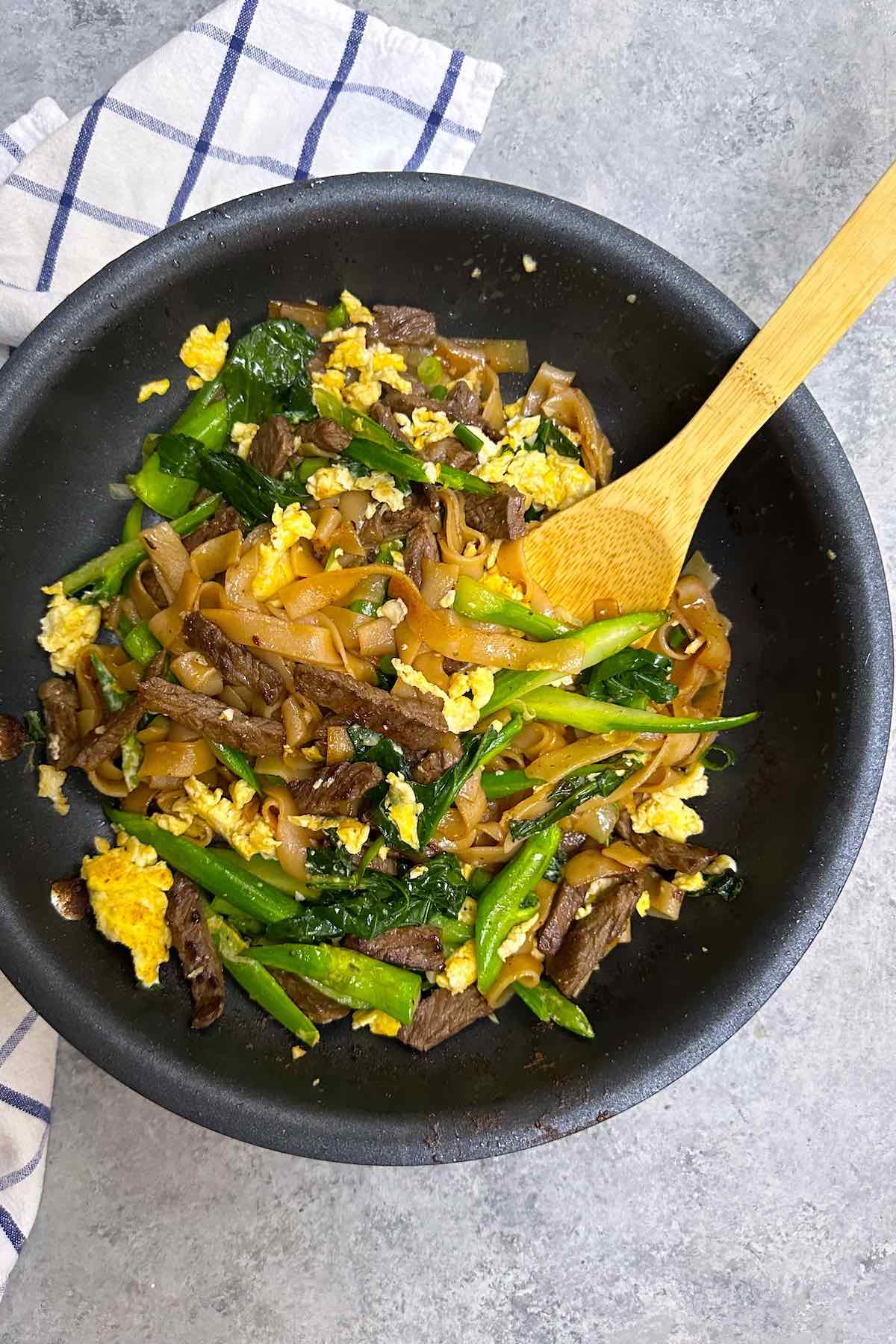 This restaurant-quality Pad See Ew is easy and comes together in under 30 minutes. Made with Thai wide rice noodles, beef, Chinese broccoli, and scrambled eggs, all tossed together in a savory and sweet Pad See Ew sauce!