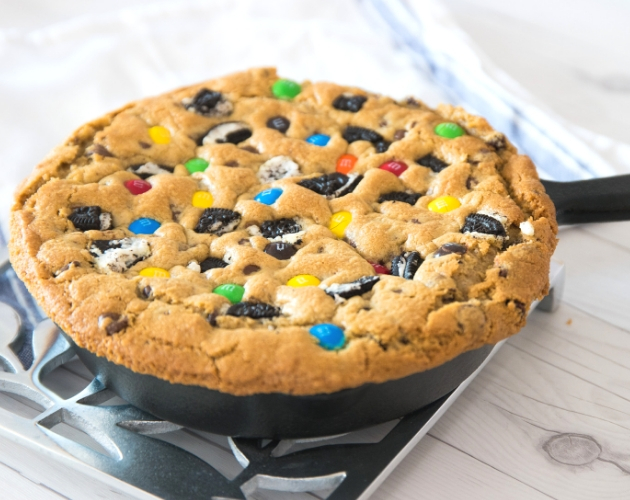 This Skillet Cookie features Reese's peanut butter cups and other candies for a delicious homemade treat