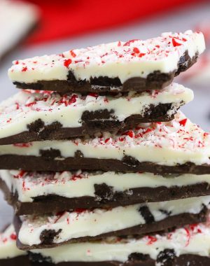 Closeup of peppermint chocolate bark showing the layers of chocolate, crushed oreos and candy cane on top