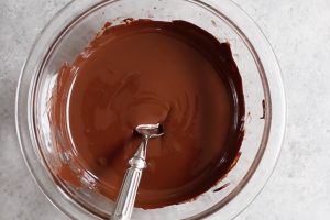 Semisweet chocolate in a mixing bowl after being smoothly melted in intervals in the microwave